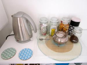 a kitchen counter with a blender and jars of food at Sherwood Garden in Cape Town