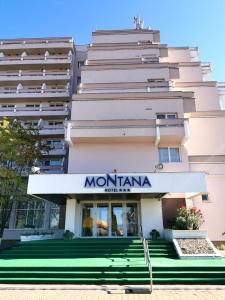 a building with a sign for montana hotel at Hotel Montana - Covasna in Covasna