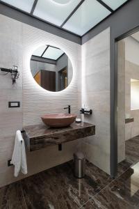 a bathroom with a large sink and a mirror at Hotel Poerio 25 Boutique Stay in Naples