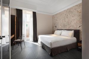 a bedroom with a large white bed and a window at Hotel Poerio 25 Boutique Stay in Naples