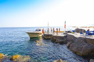 a boat is docked at a dock in the water at Grand Hotel Tritone in Praiano