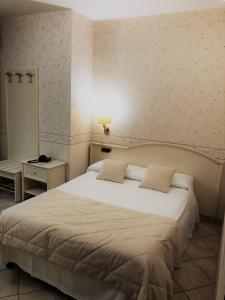 Postel nebo postele na pokoji v ubytování Hotel La Noce