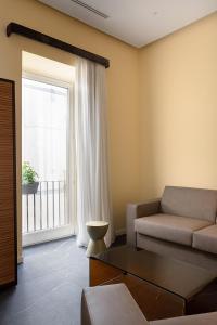 a living room with a couch and a window at Hotel Poerio 25 Boutique Stay in Naples