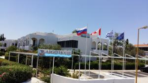 a building with a street sign in front of it at Argo Hotel in Faliraki