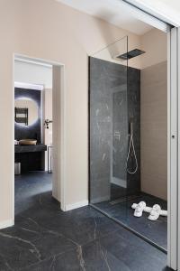 a bathroom with a shower with a glass door at Hotel Poerio 25 Boutique Stay in Naples
