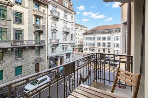 a balcony with a bench and a view of a street at Modern & Central Apartments in Luzern