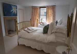 a bedroom with a white bed and a window at The Candlemakers in Hexham