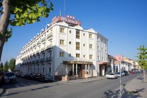 a white building with a sign on top of it at BS Principe Felipe in Albolote