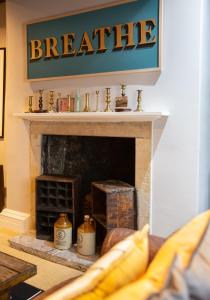 a fireplace with a sign that reads breathe at The Candlemakers in Hexham