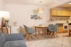 a living room with a table and chairs and a kitchen at Ferienhaus Mey in Bad Salzungen