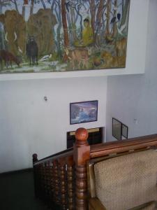 a painting on the wall next to a stairway with at Malwatta rest in Kandy