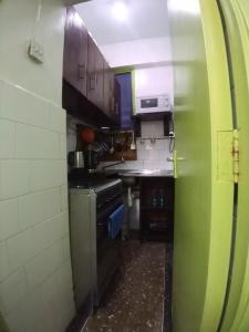 a small kitchen with a sink and a stove at SAFI Apartment in Mombasa