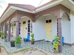 a house with plants in front of it at Desa Besut Inn in Kampung Kuala Besut