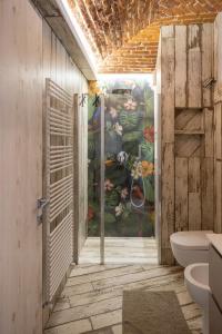 a bathroom with a painting on the wall at Casa Pappagallo in Turin