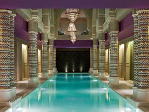 a swimming pool in a building with columns at Sofitel Legend Old Cataract in Aswan