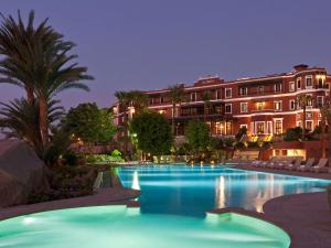 a hotel room with a pool and a beach at Sofitel Legend Old Cataract in Aswan