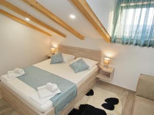 a small bedroom with a bed and a window at Apartments Sweet Escape in Dubrovnik
