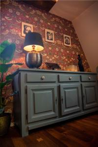 a lamp on top of a cabinet in a room at Luxury apartment in Bergen's Gastronomic district in Bergen