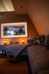 a living room with a couch and a painting on the wall at Luxury apartment in Bergen's Gastronomic district in Bergen