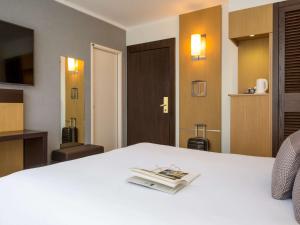Cama ou camas em um quarto em Novotel Genève Centre