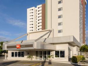 a large white building with a hotel at ibis Aracaju in Aracaju