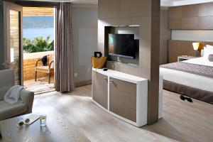 a hotel room with a bed and a television at TUI MAGIC LIFE Bodrum - Adults Only in Bodrum City