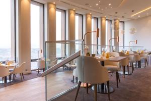 a dining room filled with tables and chairs at Radisson Blu Hotel, Lyon in Lyon