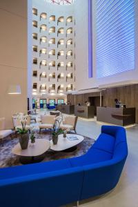 a living room filled with furniture and a large screen tv at Radisson Blu Hotel, Lyon in Lyon