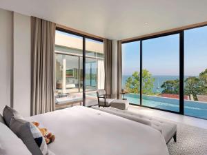 A bed or beds in a room at V Villas Phuket, MGallery - SHA Extra Plus