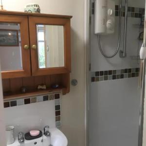 a bathroom with a sink and a shower at Entire house near beaches, footpaths, dog friendly in Barnstaple