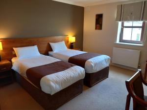 Een bed of bedden in een kamer bij Hillcrest Guest House