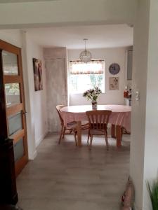 a dining room with a table and chairs and a window at Entire house near beaches, footpaths, dog friendly in Barnstaple