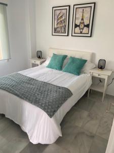 a bedroom with a large white bed with two tables at Apartment Near to Beach, Max Beach Club La Riviera-Mijas in Mijas