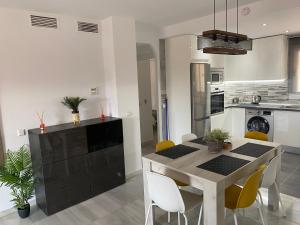 a kitchen with a dining room table and chairs at Apartment Near to Beach, Max Beach Club La Riviera-Mijas in Mijas