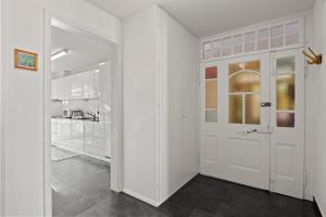 a white door in a room with a kitchen at Central Bright & Cozy Apartments in Lucerne