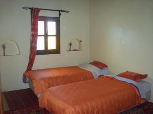 Llit o llits en una habitació de Safranière du M' Goun