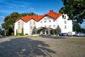 a large white building with an orange roof at Hotel Lord Gorlice in Gorlice