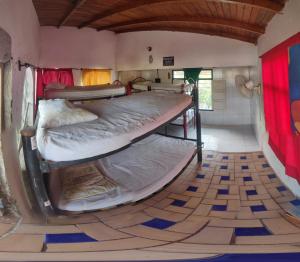 two bunk beds in a room with a tile floor at hostal alquimista in Taganga