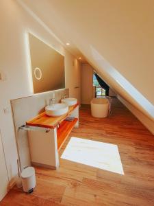 a bathroom with two sinks and a large mirror at Downhill Lodge Tauplitz in Tauplitz