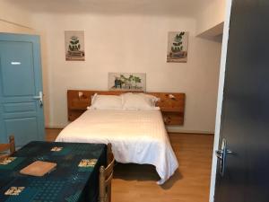a bedroom with a bed and a blue door at la dolce farniente in Dax