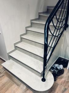 a set of stairs in a room with shoes at Maison de charme et accueillante in Chalifert