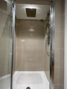 a shower with a glass door in a bathroom at No 12 Furze Croft in St Ives