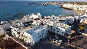 an aerial view of a city with white buildings and the ocean at Casa salzano in Playa Blanca