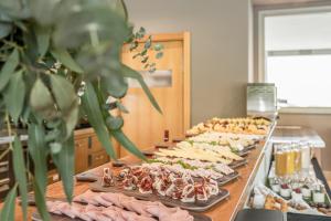 a buffet line with many different types of food at Hotel Antik San Sebastián in Donostia-San Sebastián