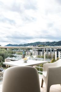 a balcony with a table and chairs and a view at Hotel Antik San Sebastián in Donostia-San Sebastián