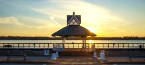 a gazebo on a pier with the sunset in the background at Solomons Victorian Inn in Solomons