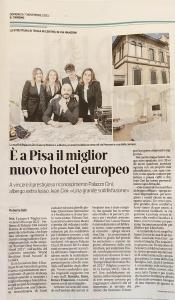 a newspaper with a picture of a group of people at Palazzo Cini Luxury Rooms in Pisa in Pisa