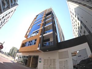 ドバイにあるBarsha Star Residence - Home Stayの側面に窓がある高い建物