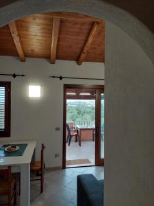 a living room with a table and a dining room at Casa Stefano 2 in Lu Lioni