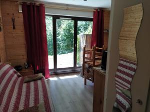 a bedroom with a large window with red curtains at appart st gervais le Topaze in Saint-Gervais-les-Bains +68 photos